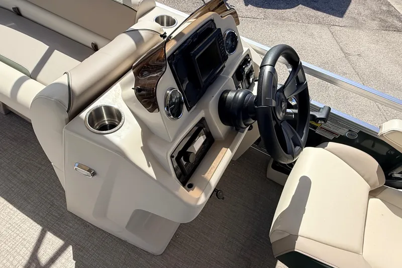 Slide: The Image of 2026 Avalon 2385 Venture 85 Quad Lounger boat interior with steering wheel and seating. - 20