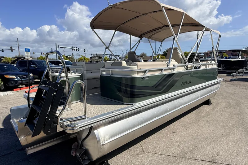 Slide: The Image of 2026 Avalon 2385 Venture 85 Quad Lounger Tri Toon boat with canopy in parking lot. - 7