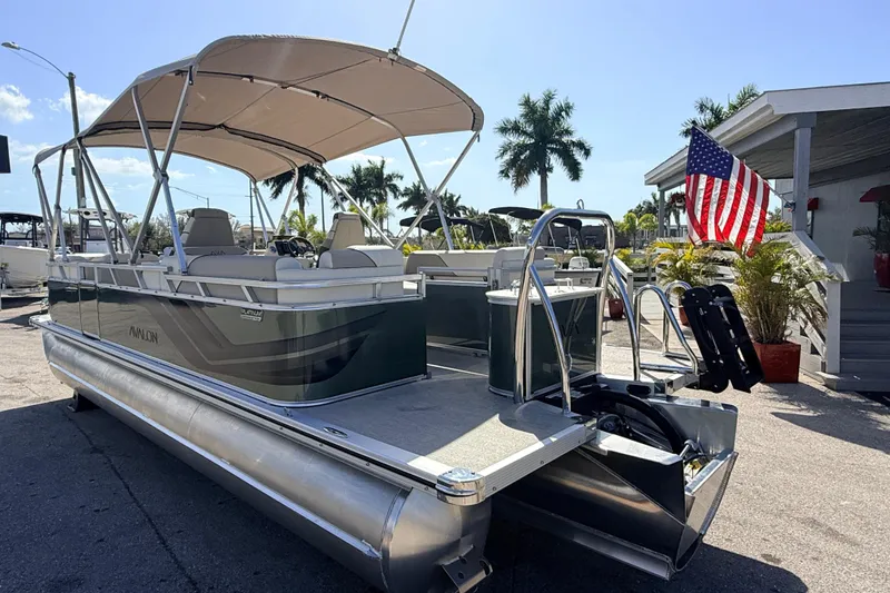 Slide: The Image of 2026 Avalon 2385 Venture 85 Quad Lounger Tri Toon boat with canopy and American flag. - 9