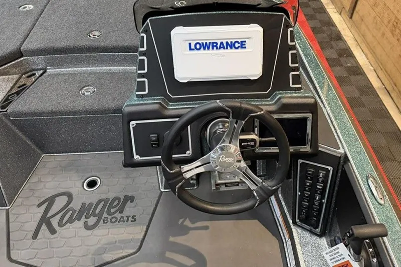 Slide: The Image of 2026 Ranger Z519R Cup-Equipped boat dashboard with Lowrance display and steering wheel. - 7