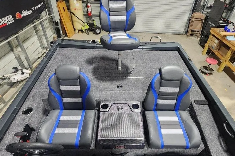 Slide: The Image of 2026 Ranger RT198P boat interior with blue and gray seats in a garage setting. - 10