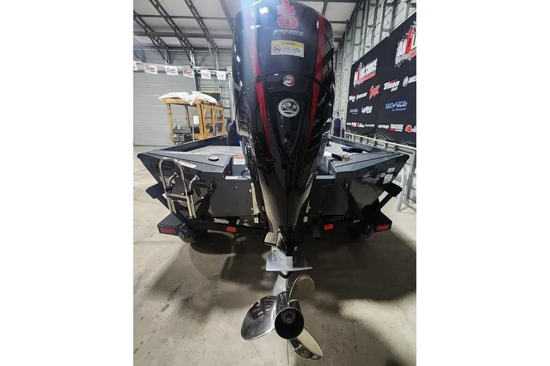 Slide: The Image of 2026 Ranger RT198P boat with powerful outboard motor in a showroom setting. - 5