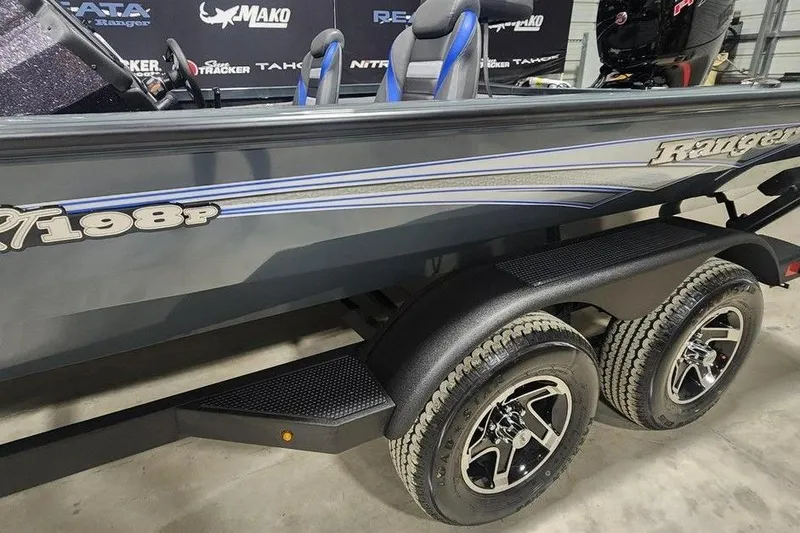 Slide: The Image of 2026 Ranger RT198P boat on trailer, showcasing sleek design and dual wheels. - 8