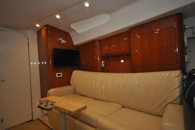 Slide: The Image of Interior of 2009 Intrepid 430 Sport Yacht with leather sofa and wooden cabinetry. - 12