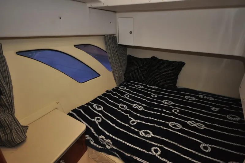 Slide: The Image of Cozy cabin interior of 2009 Intrepid 430 Sport Yacht with nautical-themed bedding. - 14