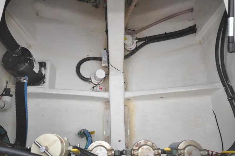 Slide: The Image of Engine compartment of a 2009 Intrepid 430 Sport Yacht, showing hoses and mechanical components. - 24