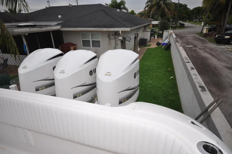 Slide: The Image of Triple Yamaha V8 engines on a 2009 Intrepid 430 Sport Yacht, parked beside a house. - 30