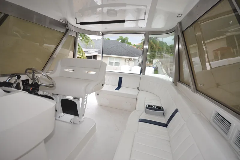 Slide: The Image of Luxurious interior of 2009 Intrepid 430 Sport Yacht with white seating and helm. - 4