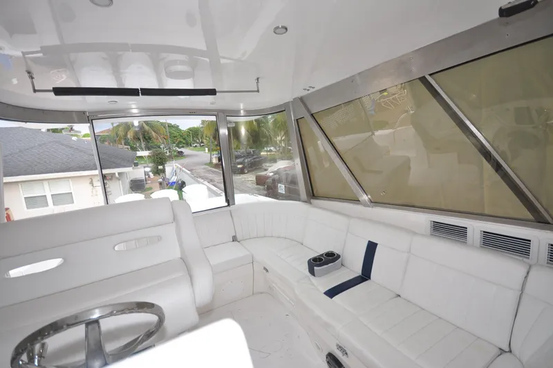 Slide: The Image of Interior of 2009 Intrepid 430 Sport Yacht with white seating and panoramic windows. - 7