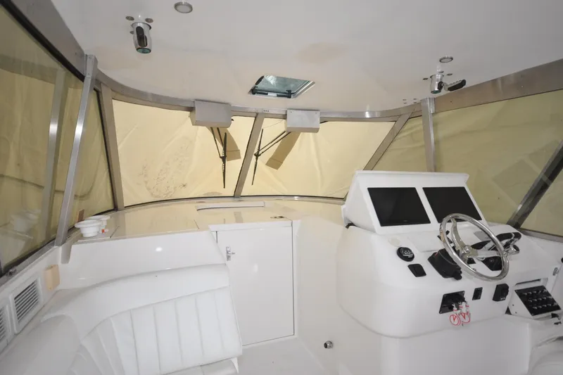 Slide: The Image of 2009 Intrepid 430 Sport Yacht helm with dual screens and steering wheel. - 8