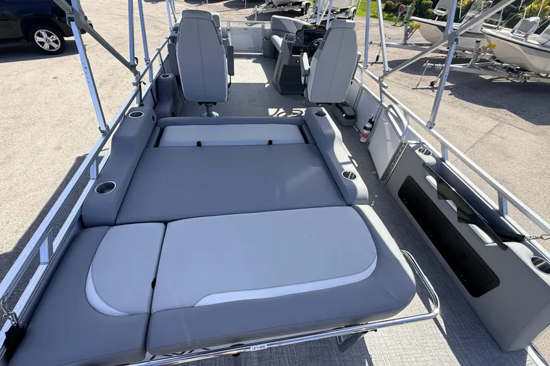 Slide: The Image of 2026 Avalon 2385 Venture 85 VRB Tri Toon boat interior with gray seating and cup holders. - 12