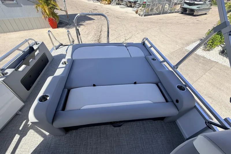 Slide: The Image of 2026 Avalon 2385 Venture 85 VRB Tri Toon boat with gray seating and cup holders. - 19