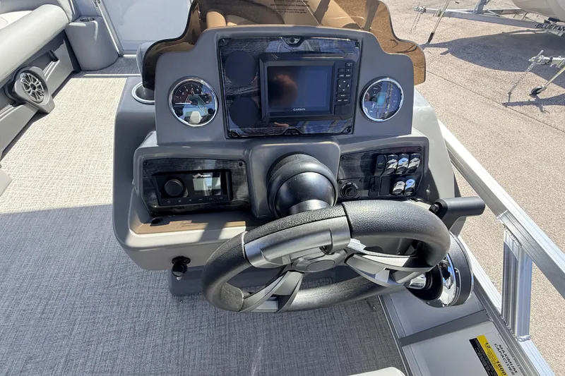 Slide: The Image of Steering console of 2026 Avalon 2385 Venture 85 VRB Tri Toon boat, featuring modern controls. - 21