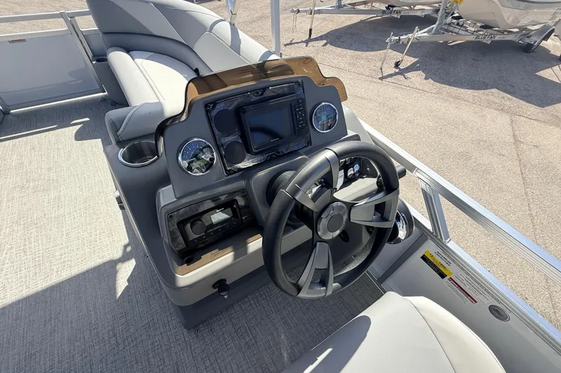 Slide: The Image of Steering console of 2026 Avalon 2385 Venture 85 VRB Tri Toon boat, featuring modern controls. - 22