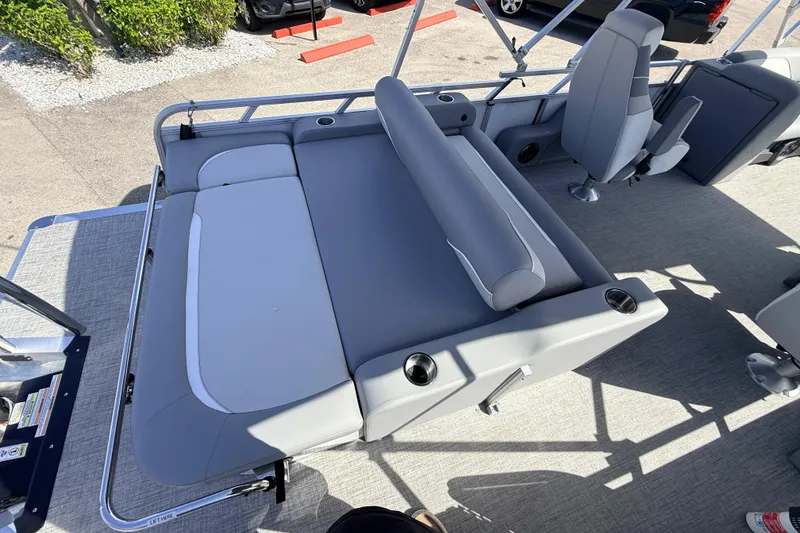Slide: The Image of 2026 Avalon 2385 Venture 85 VRB Tri Toon boat interior with gray seating and cup holders. - 24