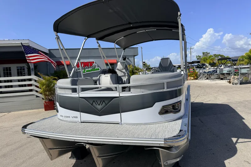 Slide: The Image of 2026 Avalon 2385 Venture Tri Toon boat at dealership, featuring sleek design and high performance. - 3
