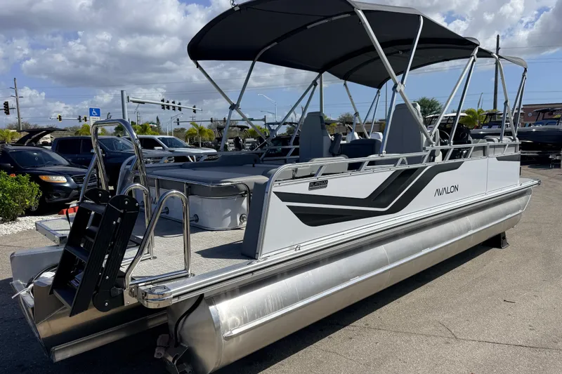 Slide: The Image of 2026 Avalon 2385 Venture 85 VRB Tri Toon boat with canopy, parked outdoors. - 6