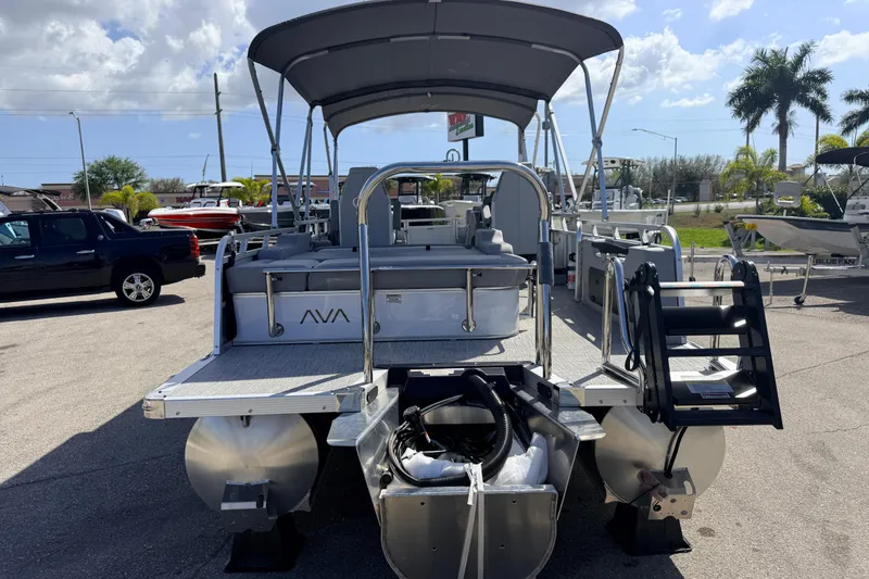 Slide: The Image of 2026 Avalon 2385 Venture 85 VRB Tri Toon boat, high performance, parked outdoors under sunny skies. - 7