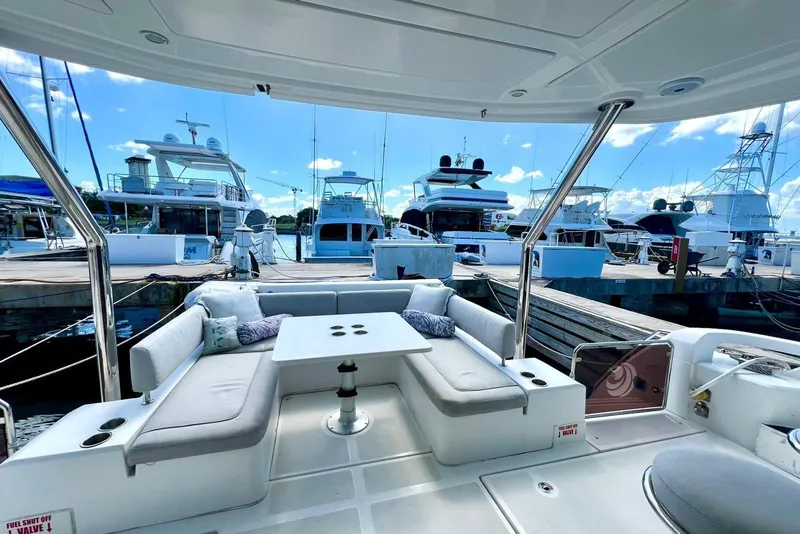 Slide: The Image of Aquila 44 Yacht 2020 interior with seating area at marina, surrounded by other boats. - 2