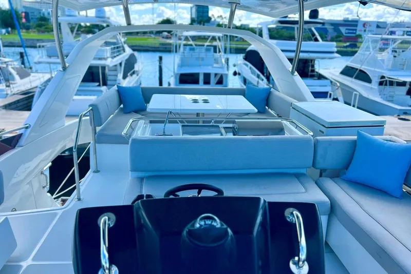 Slide: The Image of Aquila 44 Yacht 2020 model with luxurious seating and modern design at a marina. - 3