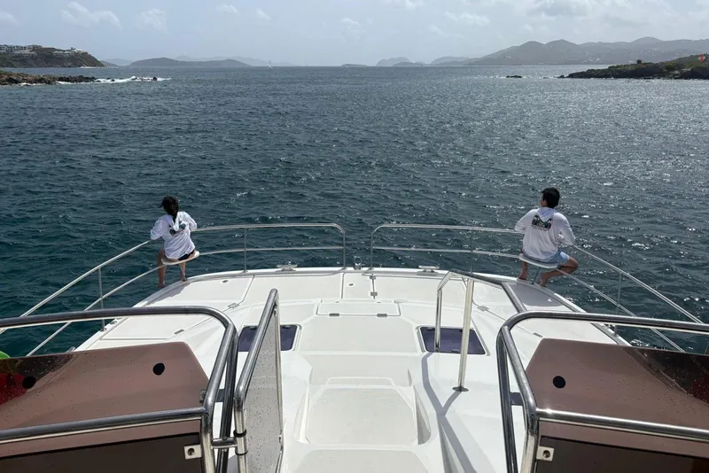 Slide: The Image of Aquila 44 Yacht 2020 cruising with two people enjoying ocean views. - 4