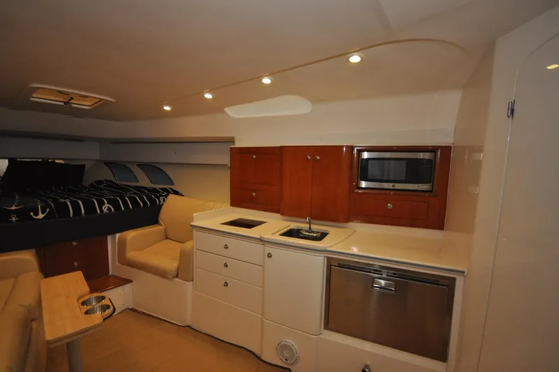 Slide: The Image of Interior of 2009 Intrepid 430 Sport Yacht with kitchenette and seating area. - 13