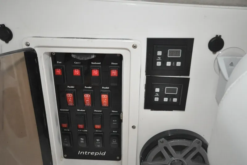 Slide: The Image of Control panel of a 2009 Intrepid 430 Sport Yacht with switches and digital displays. - 21