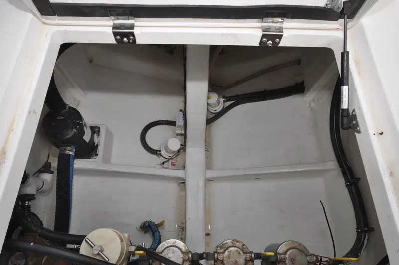Slide: The Image of Engine compartment of a 2021 Intrepid 430 Sport Yacht, showcasing mechanical components and wiring. - 28