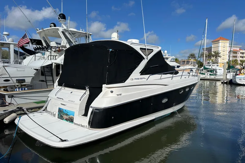 The Image of 2008 Regal Commodore 4060 yacht docked in marina under clear blue sky. - 1