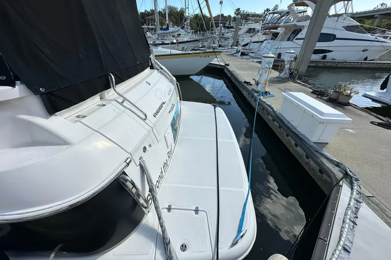 Slide: The Image of 2008 Regal Commodore 4060 yacht docked at marina, surrounded by other boats. - 11