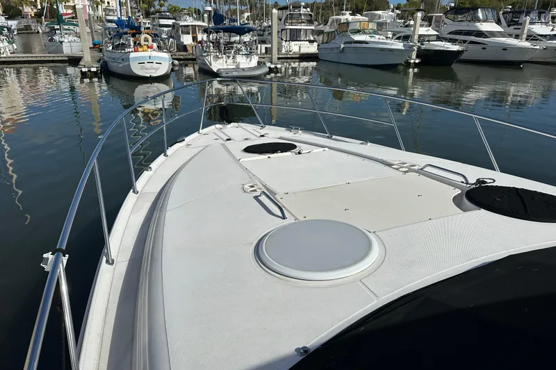 Slide: The Image of 2008 Regal Commodore 4060 yacht docked in marina, surrounded by other boats. - 12