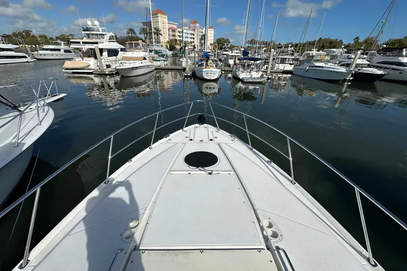 Slide: The Image of Bow view of 2008 Regal Commodore 4060 yacht docked in a marina. - 14