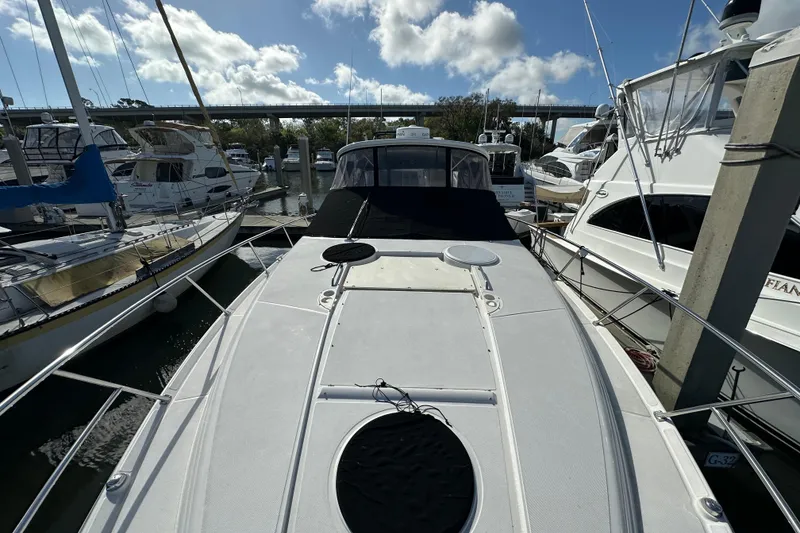 Slide: The Image of 2008 Regal Commodore 4060 yacht docked at marina under blue sky. - 15