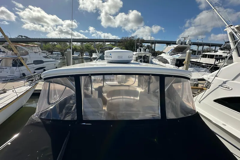 Slide: The Image of 2008 Regal Commodore 4060 yacht docked at marina under blue sky. - 18