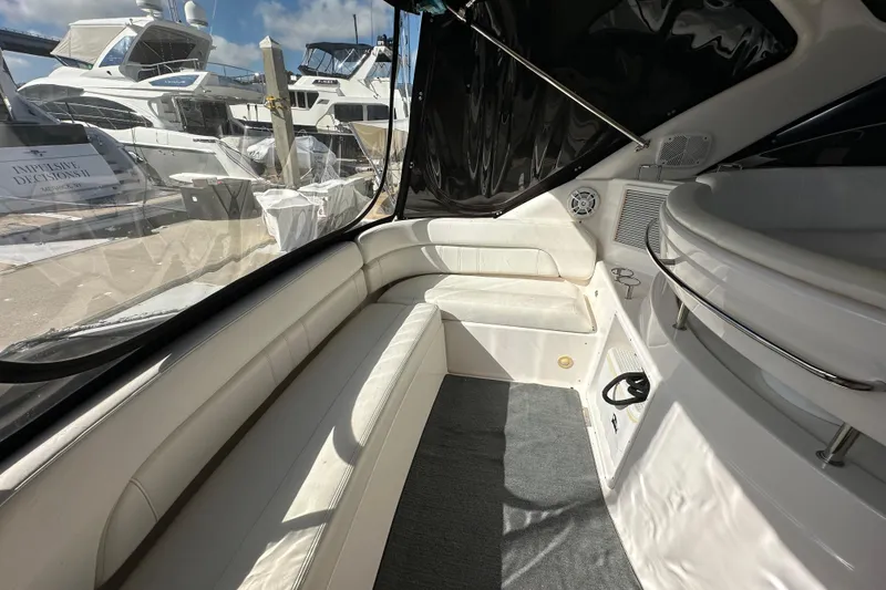 Slide: The Image of Interior of 2008 Regal Commodore 4060 yacht with white seating and marina view. - 20