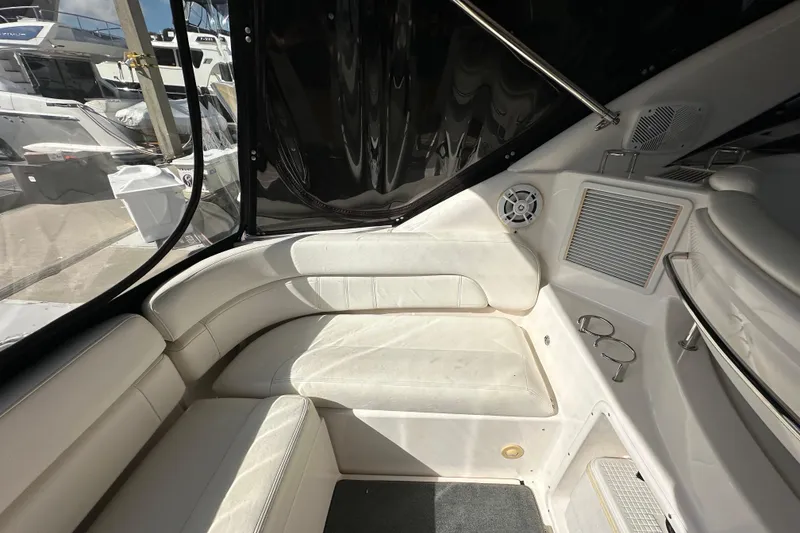 Slide: The Image of 2008 Regal Commodore 4060 yacht interior with white seating and cup holders. - 21