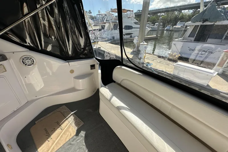 Slide: The Image of Interior view of 2008 Regal Commodore 4060 yacht at marina, featuring seating and dockside scenery. - 23