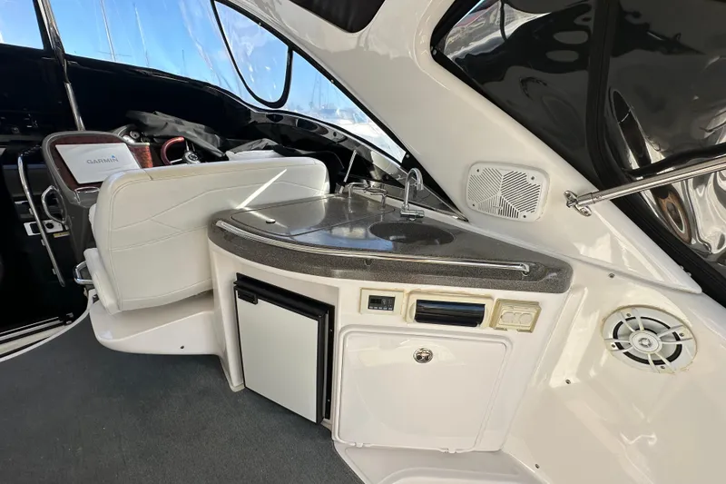 Slide: The Image of 2008 Regal Commodore 4060 yacht interior with kitchenette and seating area. - 25