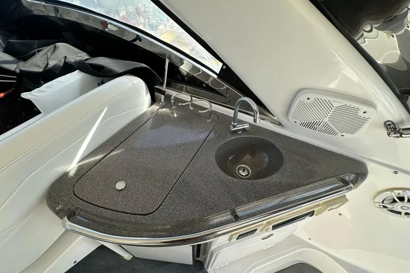 Slide: The Image of 2008 Regal Commodore 4060 boat interior with sleek kitchenette and modern sink design. - 26