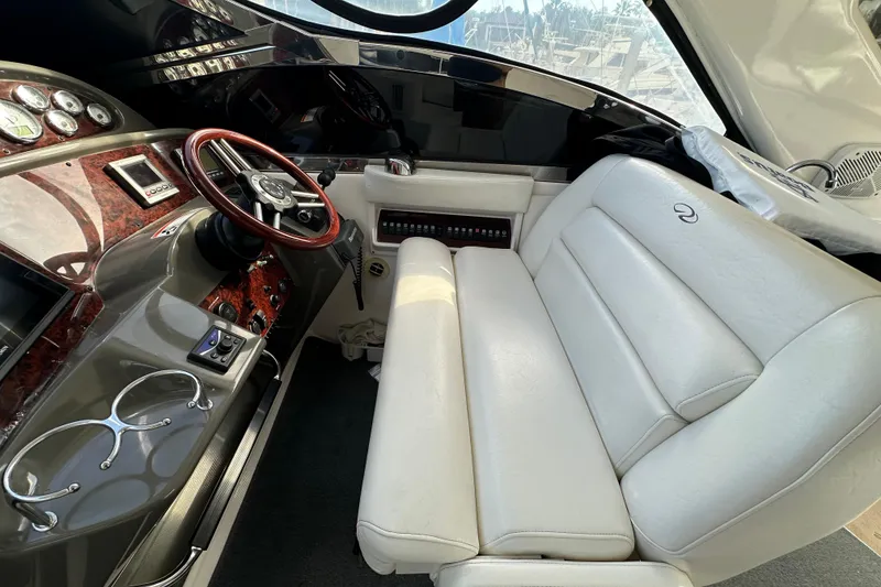 Slide: The Image of Interior of 2008 Regal Commodore 4060 yacht with white leather seating and wood-accented dashboard. - 31