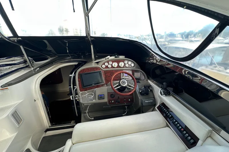 Slide: The Image of 2008 Regal Commodore 4060 yacht cockpit with steering wheel and navigation controls. - 36