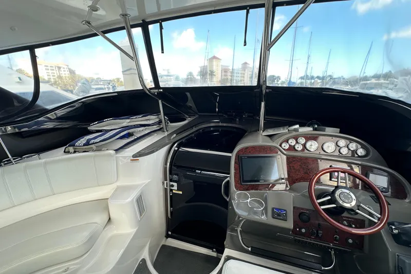 Slide: The Image of 2008 Regal Commodore 4060 yacht cockpit with steering wheel and control panel. - 39