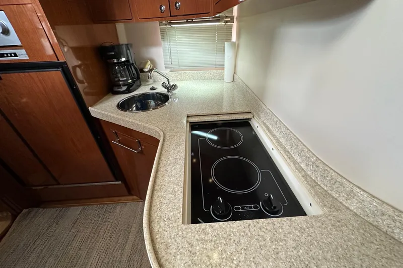 Slide: The Image of 2008 Regal Commodore 4060 yacht kitchen with stove, sink, and coffee maker. - 50
