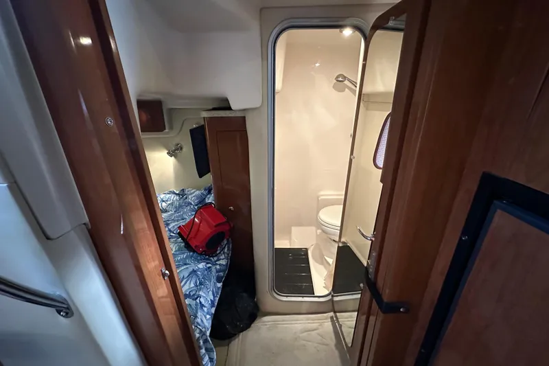 Slide: The Image of 2008 Regal Commodore 4060 cabin interior with bed and bathroom view. - 53