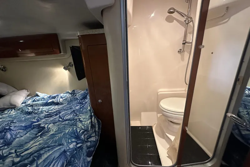 Slide: The Image of 2008 Regal Commodore 4060 interior with cozy bed and compact bathroom. - 56