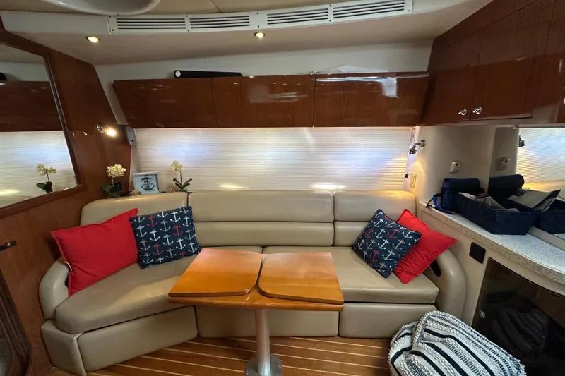 Slide: The Image of Interior of 2008 Regal Commodore 4060 yacht with beige seating and nautical-themed cushions. - 60