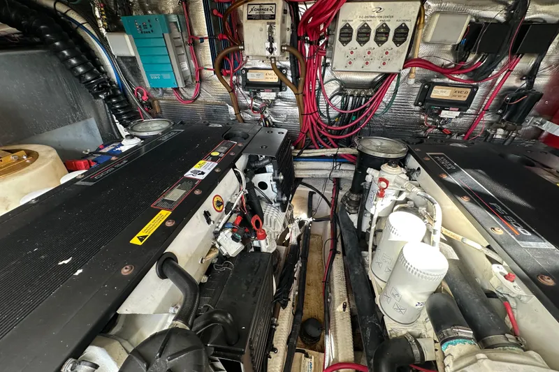 Slide: The Image of Engine room of a 2008 Regal Commodore 4060 with complex wiring and machinery. - 73