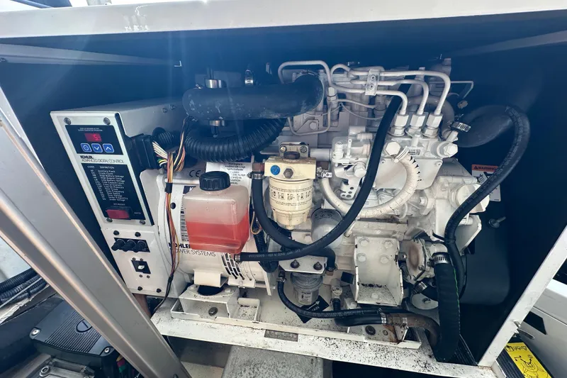 Slide: The Image of Engine compartment of 2008 Regal Commodore 4060 boat, showcasing mechanical components and control systems. - 74