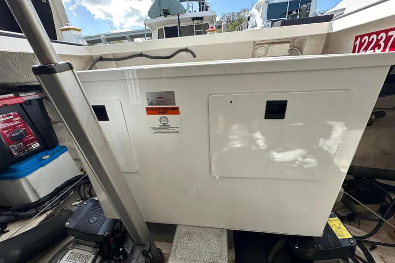 Slide: The Image of 2008 Regal Commodore 4060 boat engine compartment with fire extinguisher port. - 76