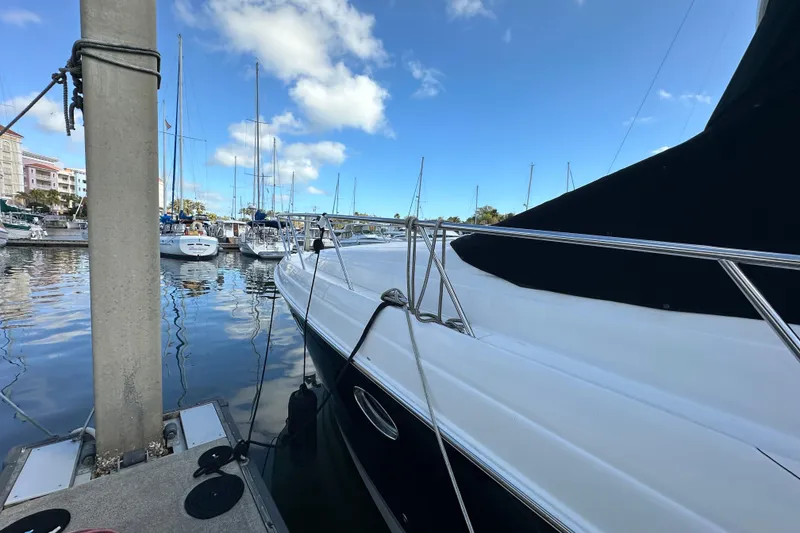 Slide: The Image of 2008 Regal Commodore 4060 yacht docked in a marina under a clear blue sky. - 8
